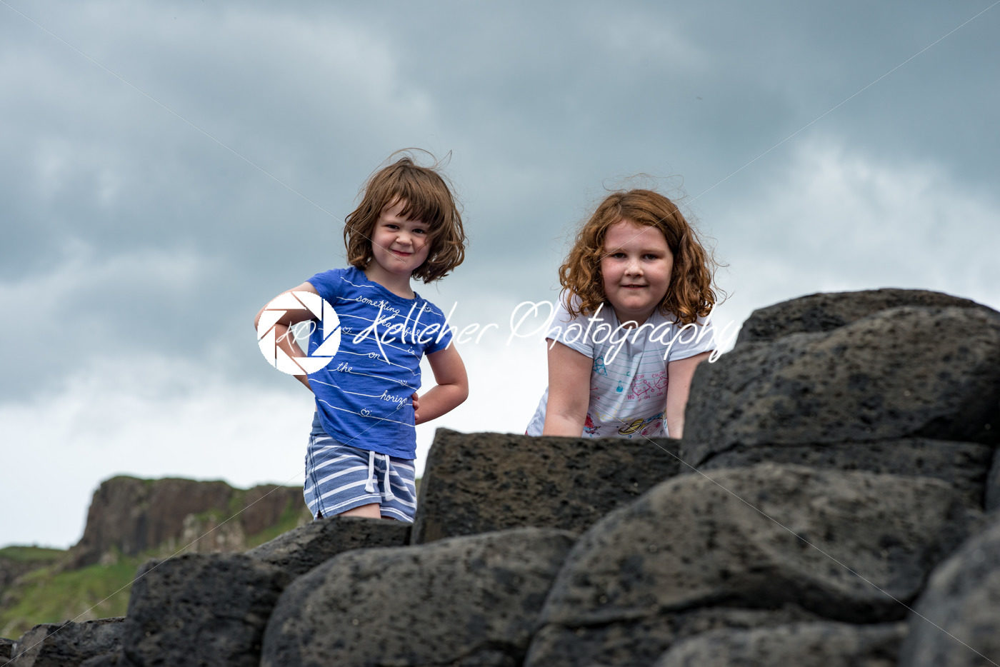 Siblings climbing the rocks at Giant’s Causeway - Kelleher Photography Store