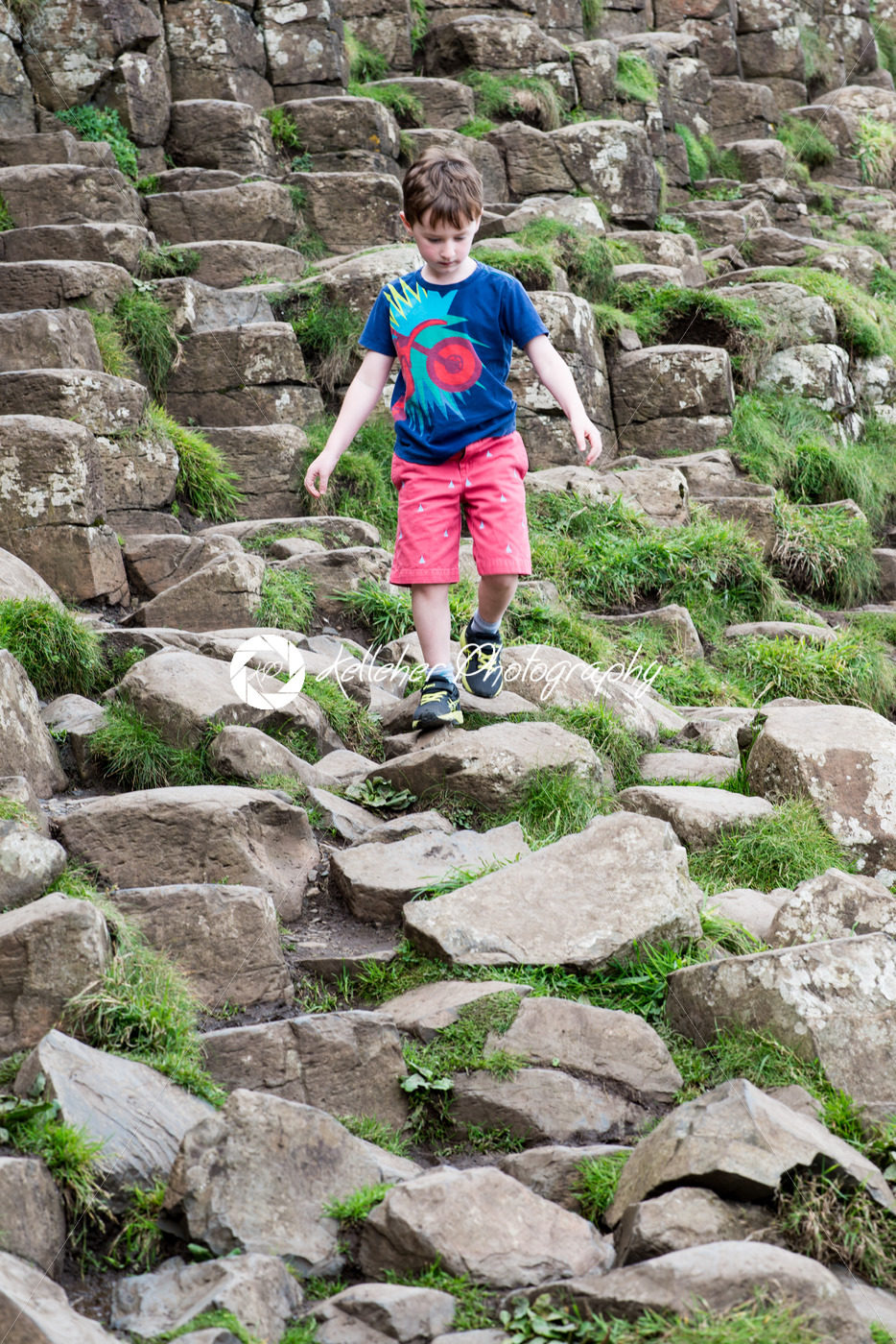 Young Boy walking on the rocks at Giant’s Causeway - Kelleher Photography Store