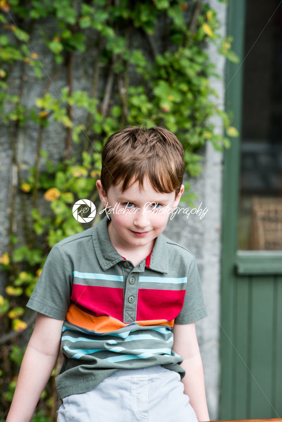 Young little boy portrait sitting down looking at camera - Kelleher Photography Store