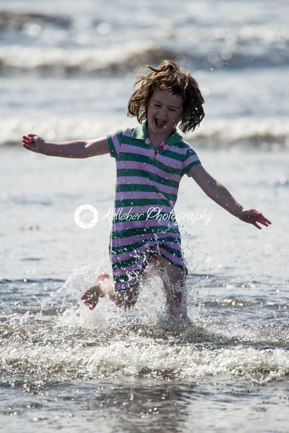 Young little girl on beach playing in the surf - Kelleher Photography Store