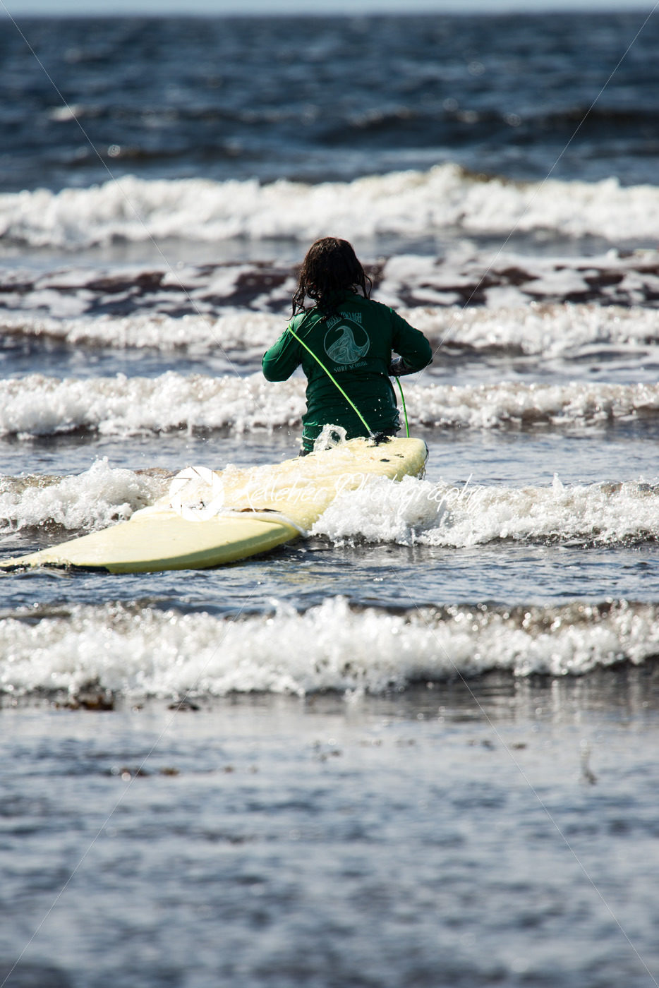 Young little girl on beach taking surfing lessons - Kelleher Photography Store