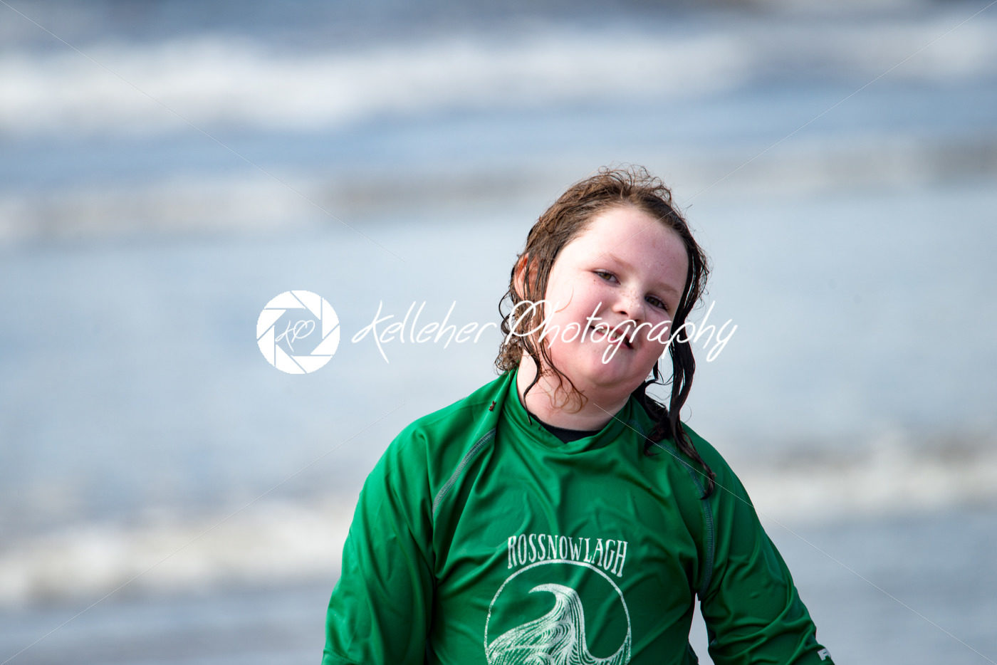 Young little girl on beach taking surfing lessons - Kelleher Photography Store