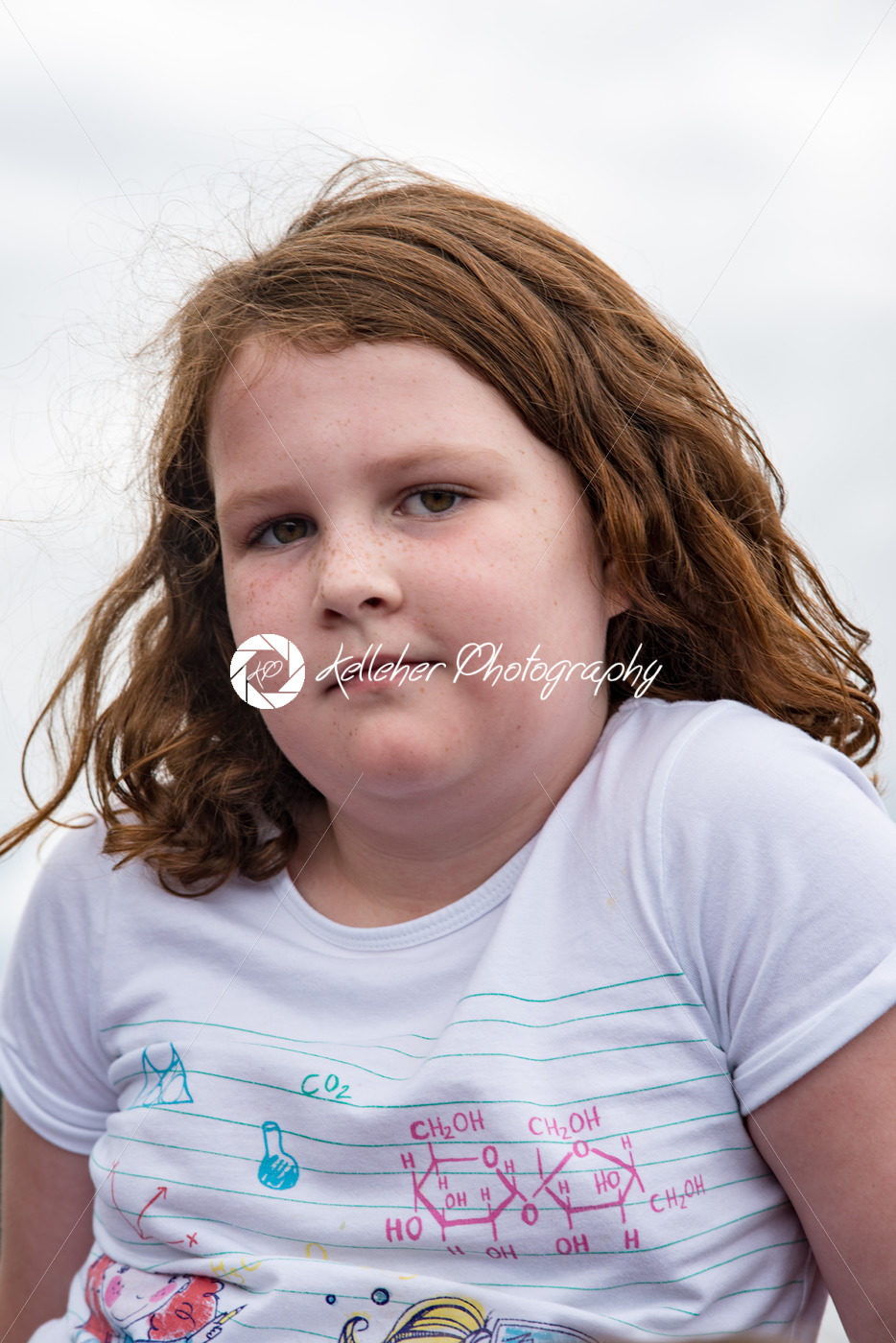 Young little girl portrait looking and smiling at the camera. - Kelleher Photography Store
