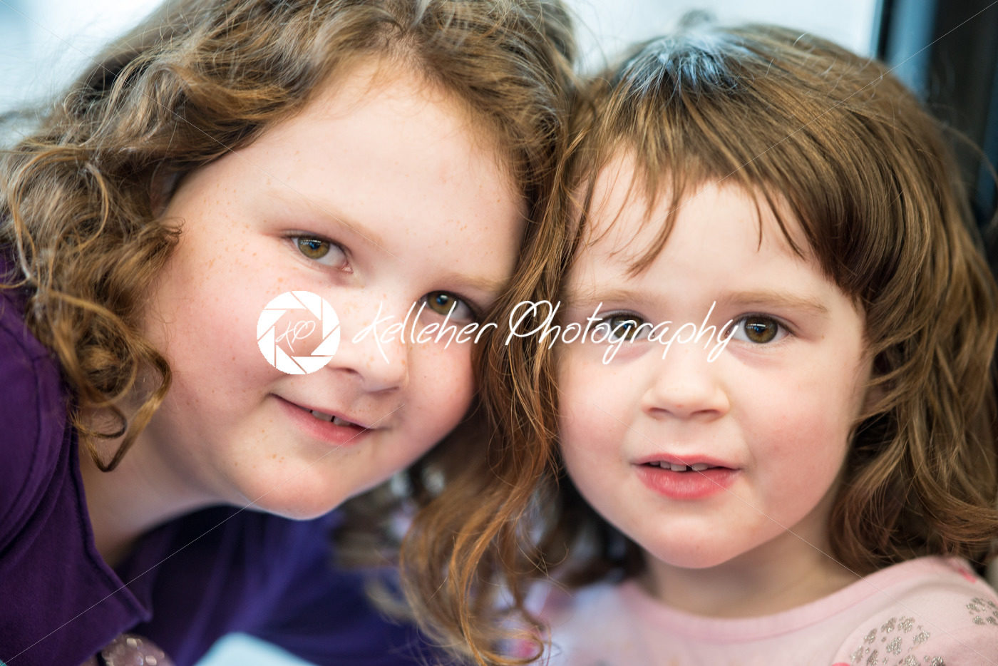 Young sibling girls portrait looking and smiling at the camera. - Kelleher Photography Store
