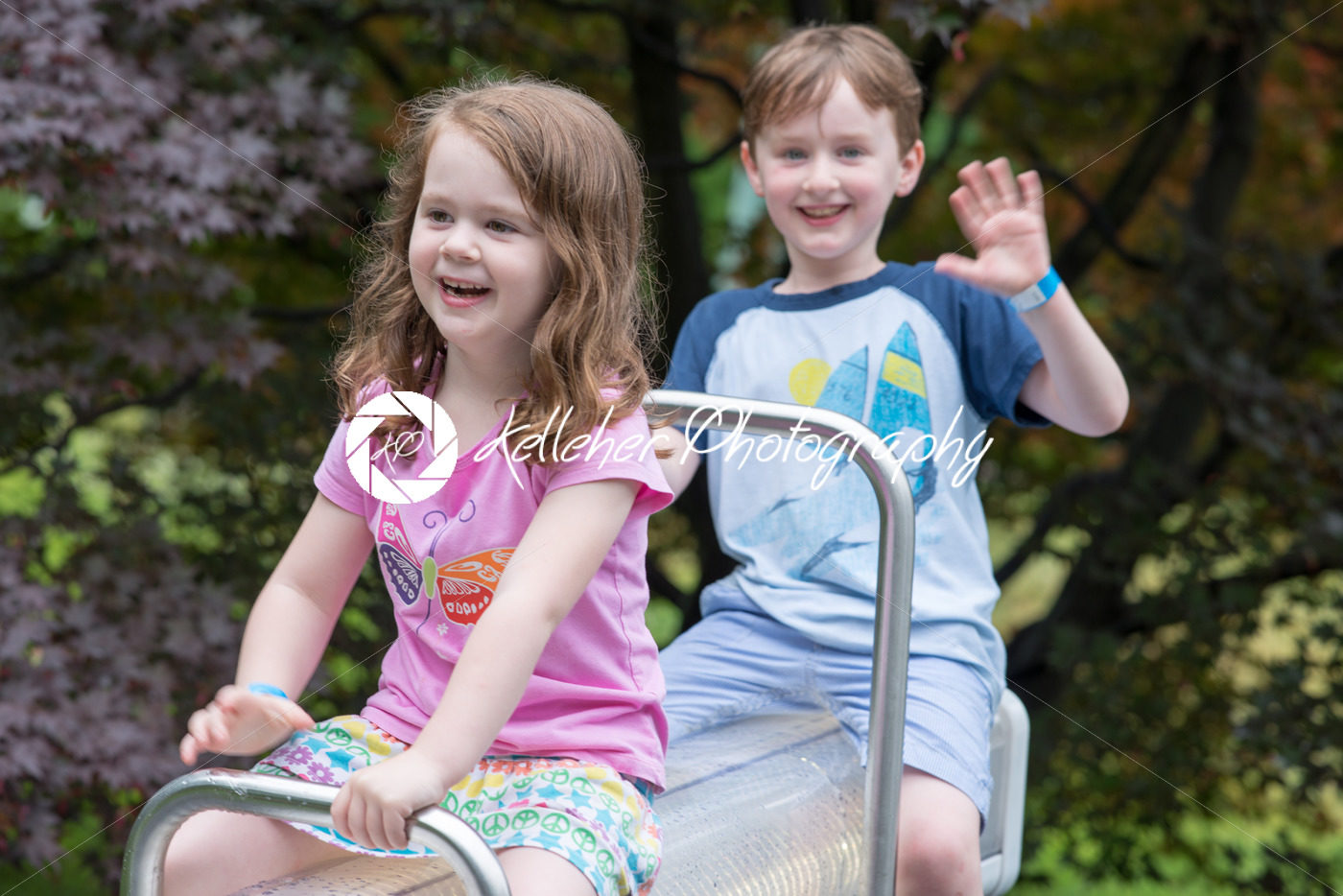 Happy brother and sister playing in park - Kelleher Photography Store