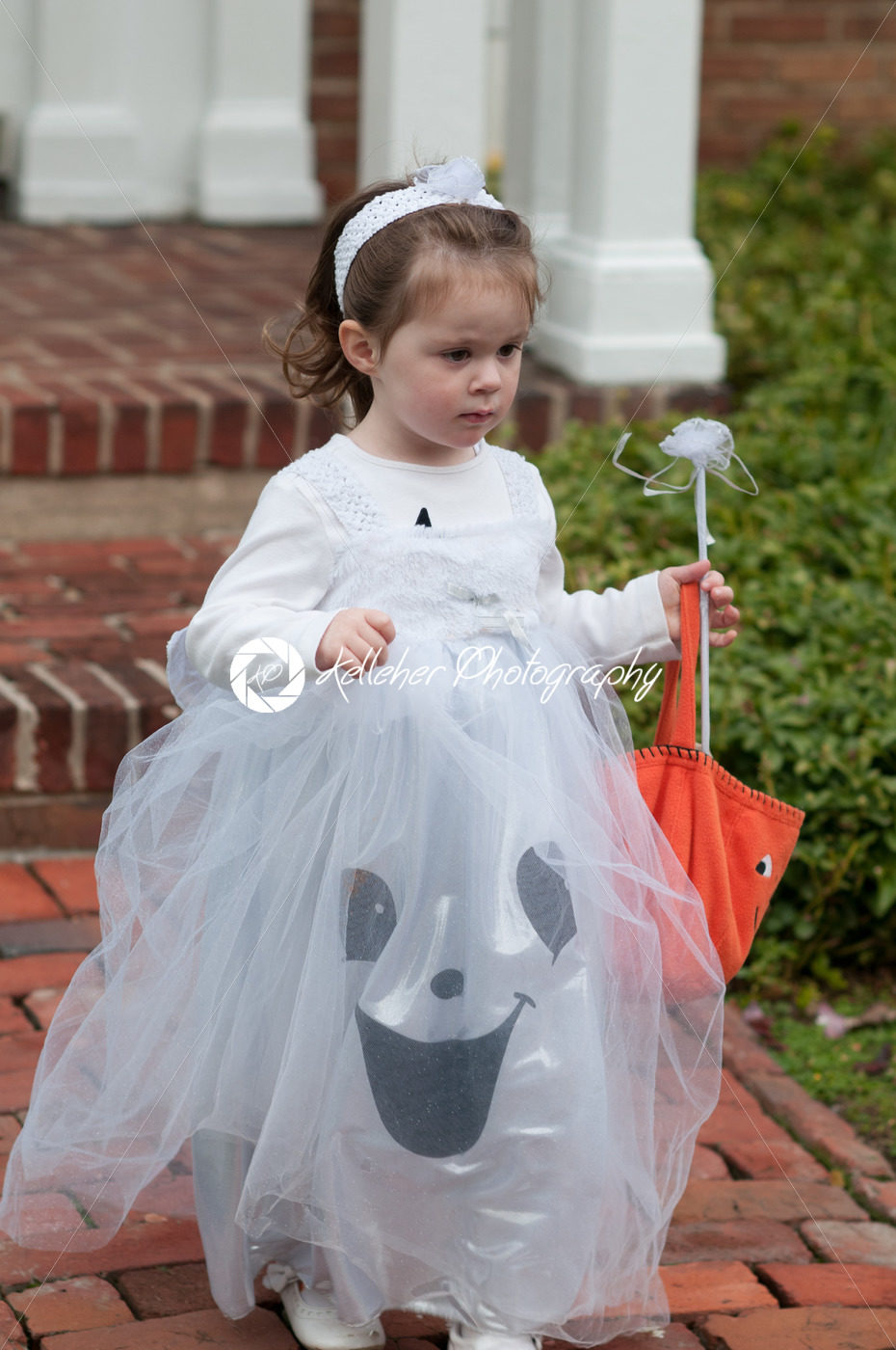 Little girl in witch costume having fun at Halloween trick or treat - Kelleher Photography Store