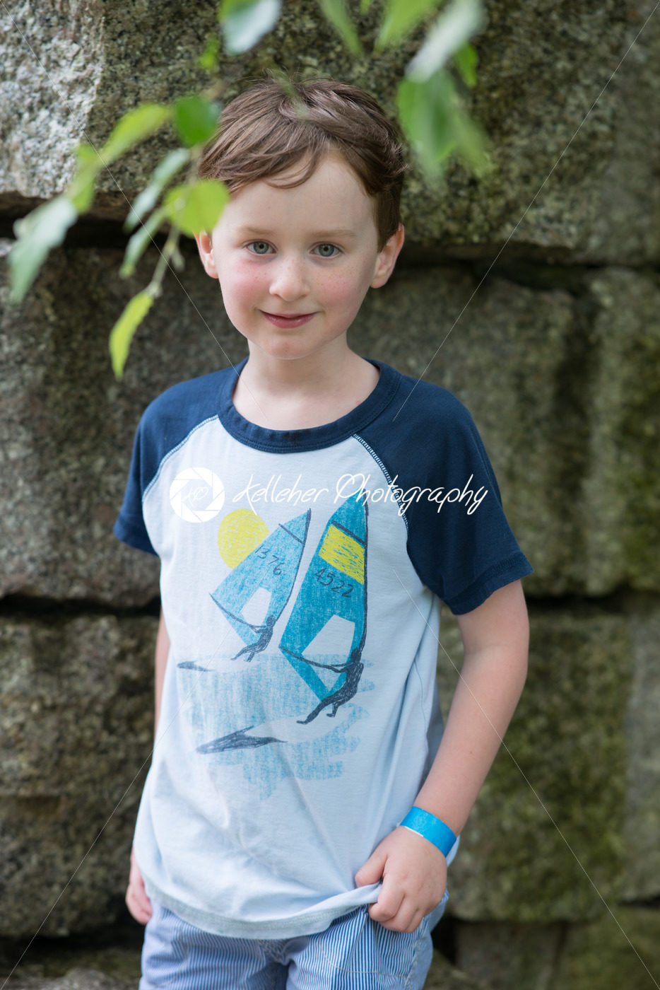 Smiling young boy standing outdoors - Kelleher Photography Store