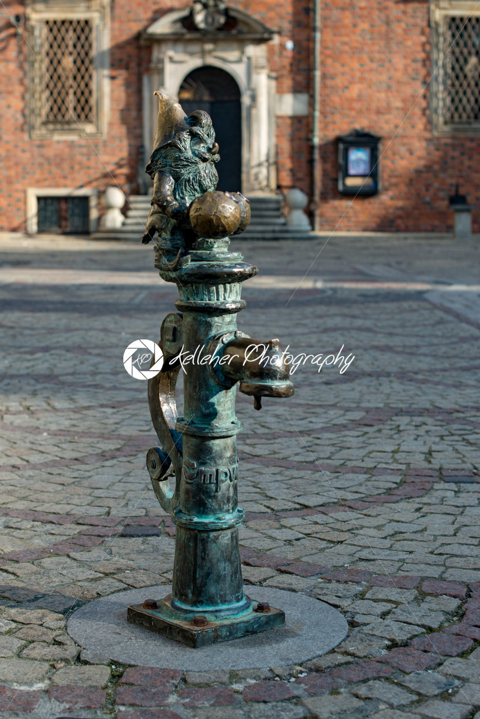 Wroclaw, Poland – March 4, 2018: Gnome on water pipe Wroclaw Market Square in evening in historic capital of Silesia, Poland, Europe. - Kelleher Photography Store