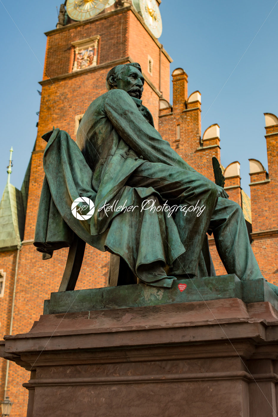 Wroclaw, Poland – March 4, 2018: Neoclassical bronze statue of famous Polish writer Alexander Fredro, 1897, by Leonard Marconi in warm sunlight in Market Square - Kelleher Photography Store