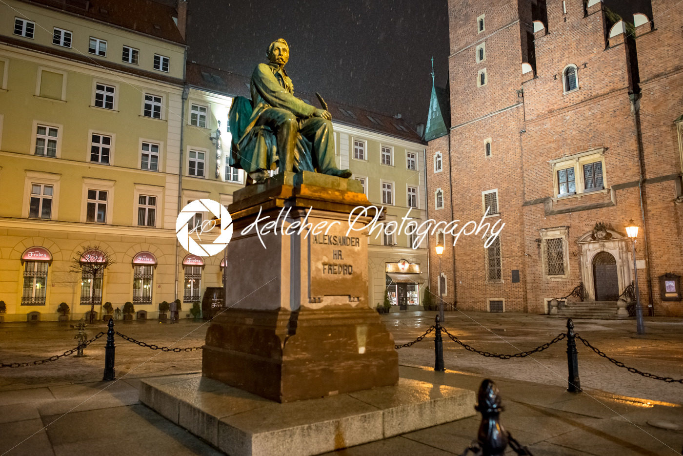 Wroclaw, Poland – March 6, 2018: Neoclassical bronze statue of famous Polish writer Alexander Fredro, 1897, by Leonard Marconi at night, Market Square - Kelleher Photography Store