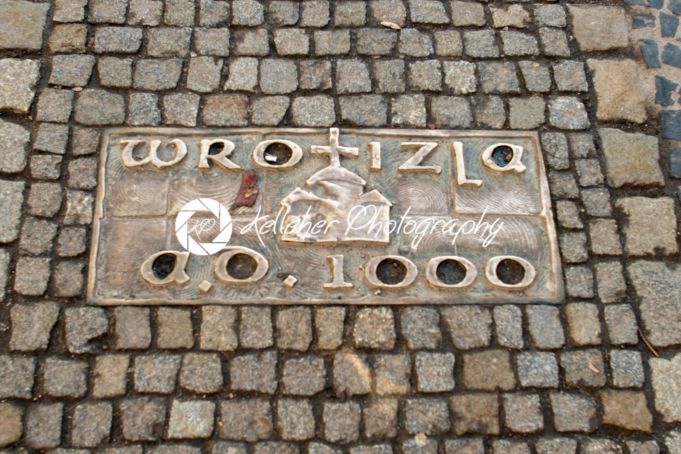 Wroclaw, Poland – March 9, 2018: One of the metal plaques on Wroclaw’s Sidewalk Timeline commemorating influential dates - Kelleher Photography Store