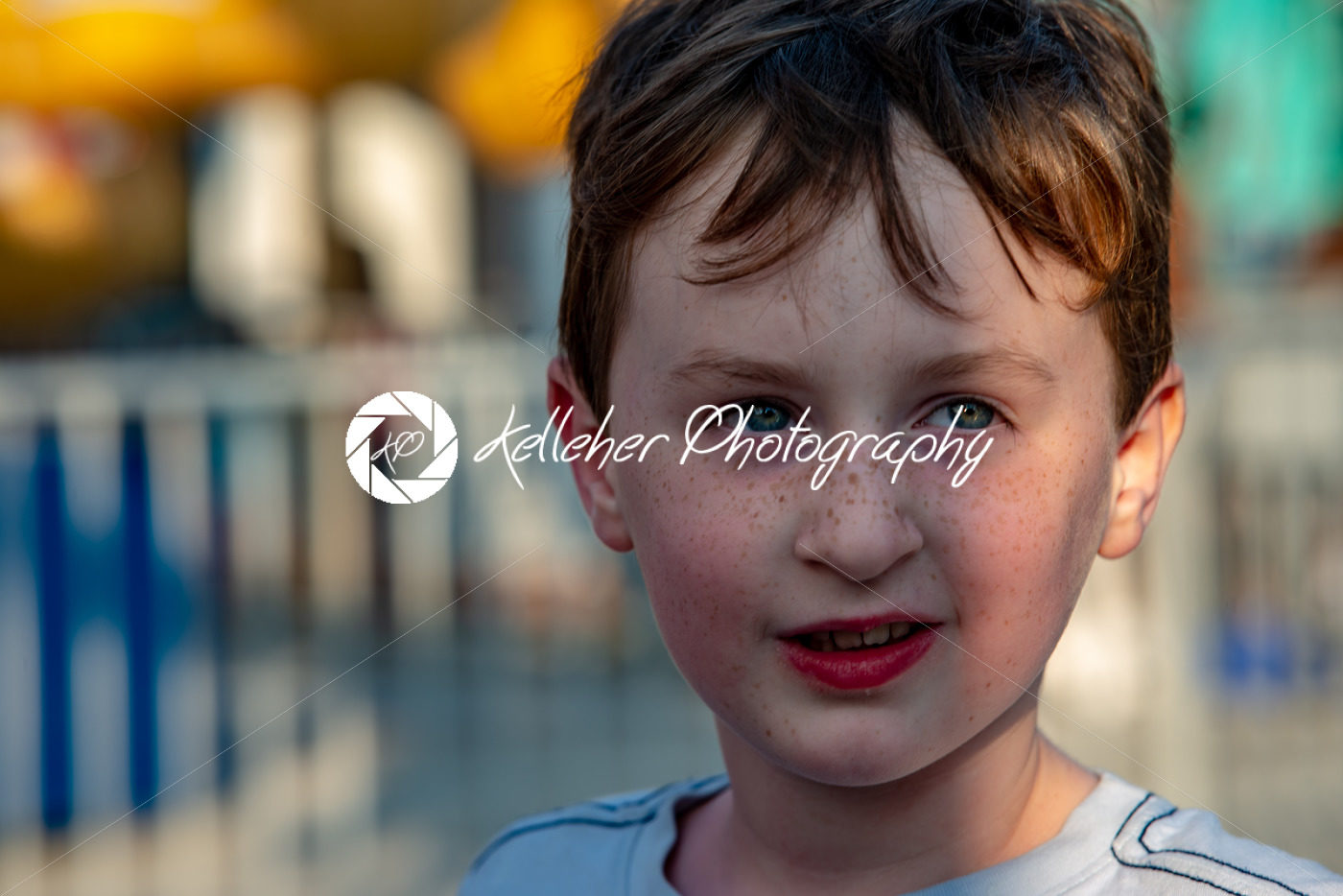 Happy young boy having fun on boardwalk amusement ride - Kelleher Photography Store