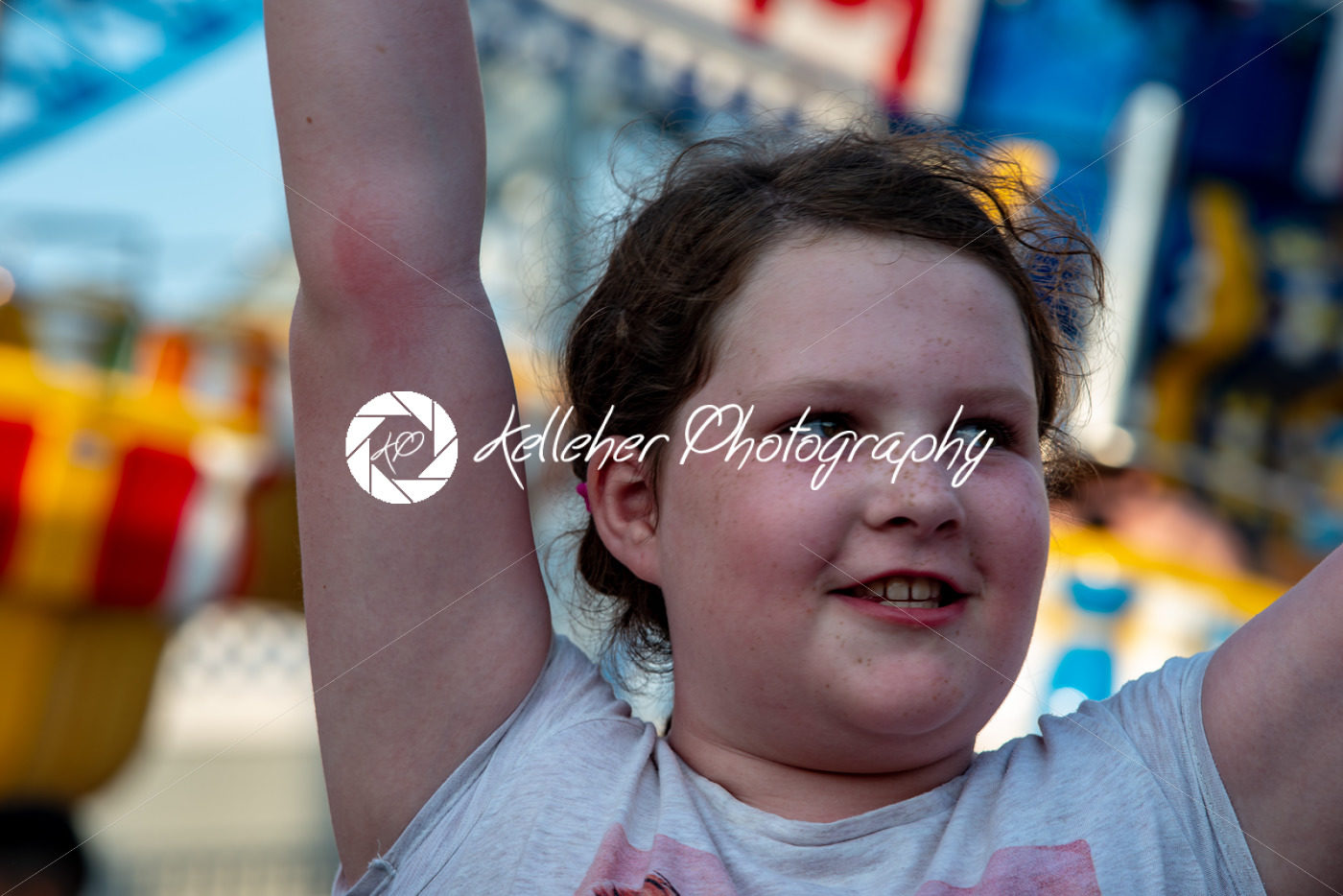 Happy young girl having fun on boardwalk amusement ride - Kelleher Photography Store