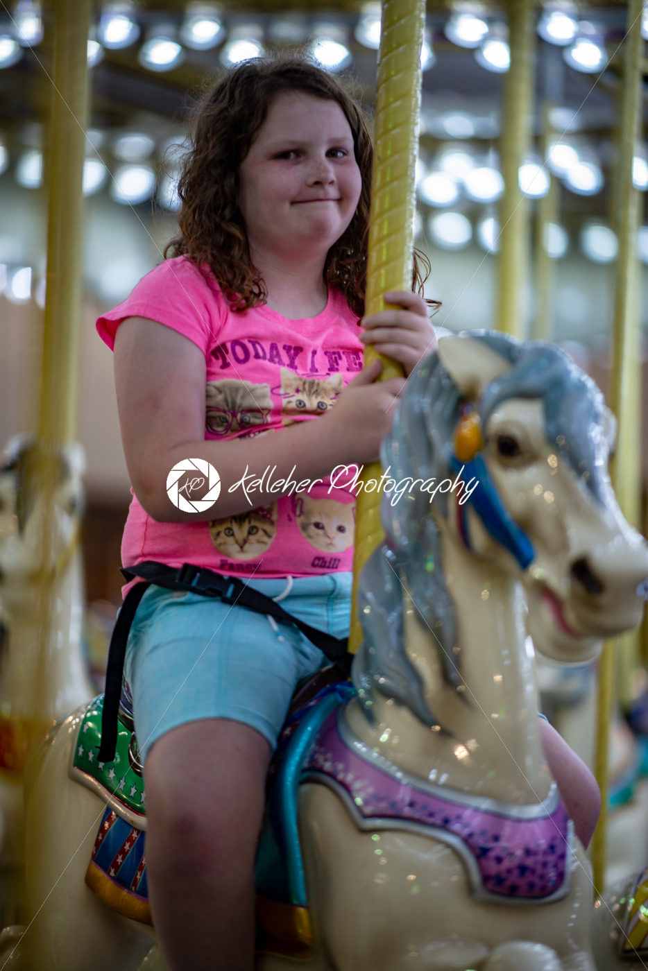 Happy young girl having fun on boardwalk amusement ride - Kelleher Photography Store