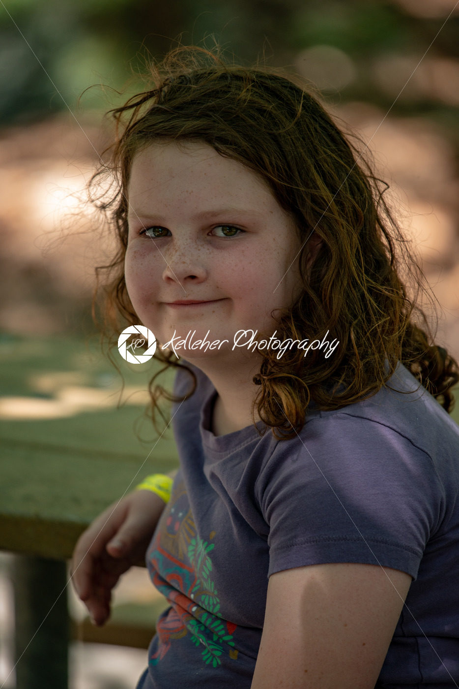 Portrait of a beautiful girl on a rope park among trees. Children summer activities. - Kelleher Photography Store
