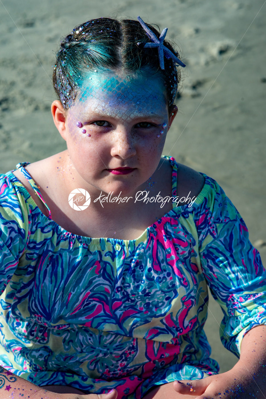 Portrait of a beautiful young mermaid girl playing in the ocean surf at the beach on a sunny day - Kelleher Photography Store
