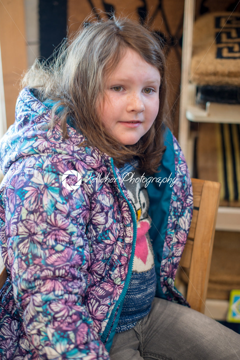 Pretty young girl sits in chair all dressed up for Easter holidays - Kelleher Photography Store