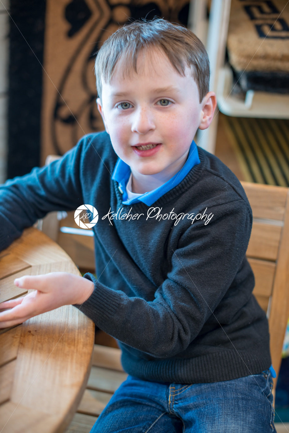 handsome young boy sits in chair all dressed up for Easter holidays - Kelleher Photography Store