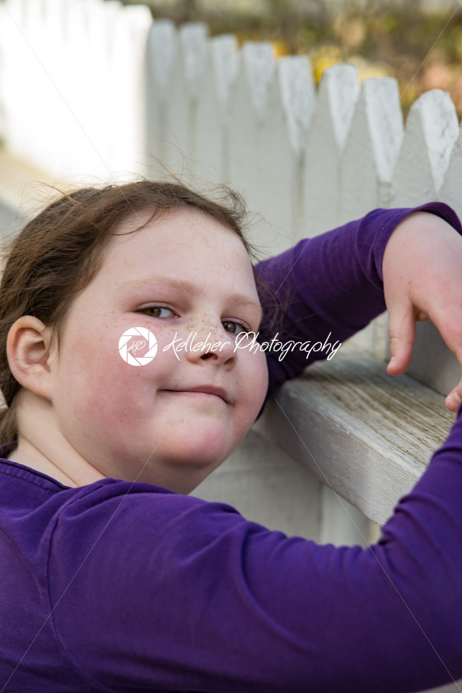 young girl posing leaning on picket fence - Kelleher Photography Store